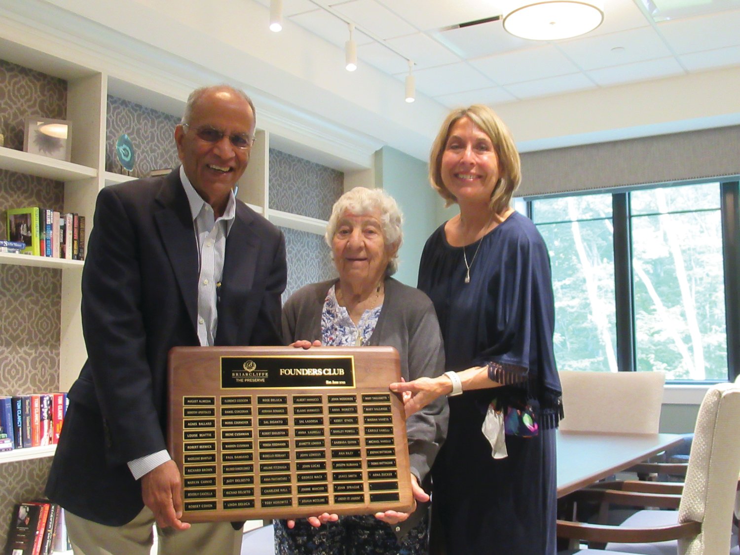 FANTASTIC FOUNDER: Anna Laurelli, 94, had the honor of holding The Preserve Founder’s Club permanent plaque along with Briarcliffe Own4r Akshay Talwar and Marketing Director Stefany Reed during last week’s posh party in Johnston.